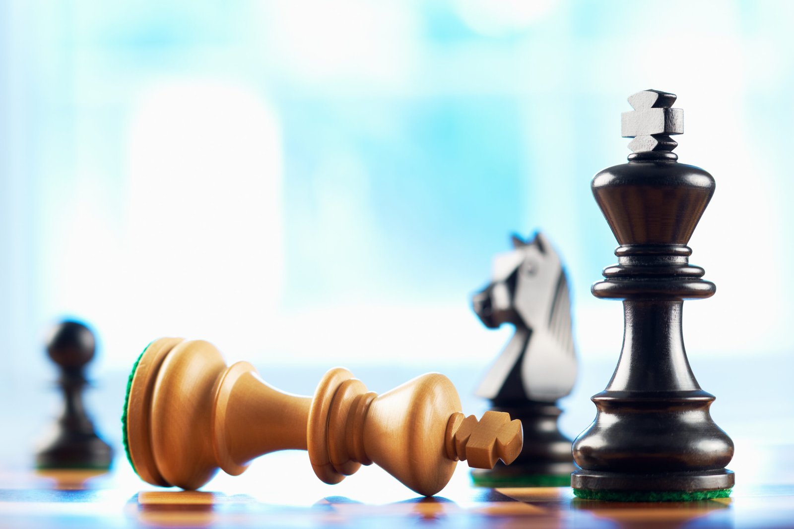 chess winner defeats white king abstract blue background
